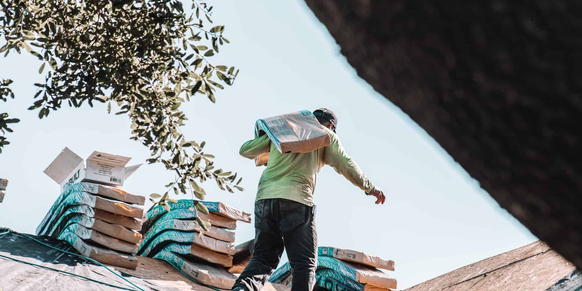 man carrying shingles man carrying shingles