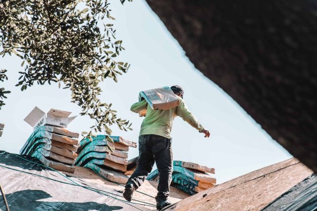 man carrying shingles man carrying shingles