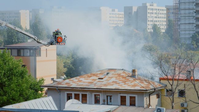 close-up-of-firefighters-on-platform-truck-helping-2021-12-09-17-04-24-utc fire