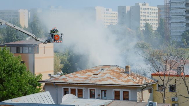 rsz_close-up-firefighters-platform-truck-helping-with-fire-from-burning-building-firemen-with-equipment-water-working-extinguish-flames-roof-house-city-landscape Smoke and Soot